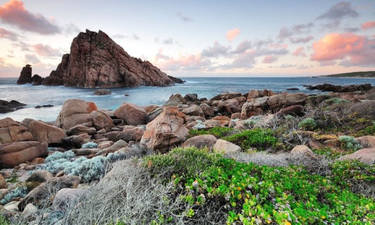 Rocky coastal headland at sunset with ocean views
